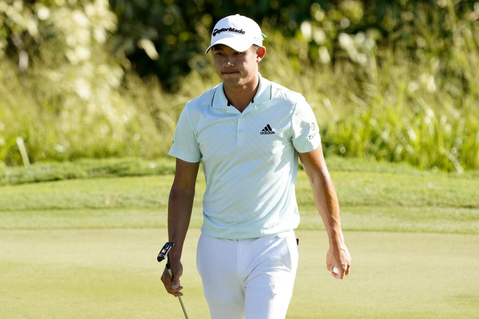 Collin Morikawa walks off the first green after making par during the final round of the Tournament of Champions golf event, Sunday, Jan. 9, 2022, at Kapalua Plantation Course in Kapalua, Hawaii. (AP Photo/Matt York)