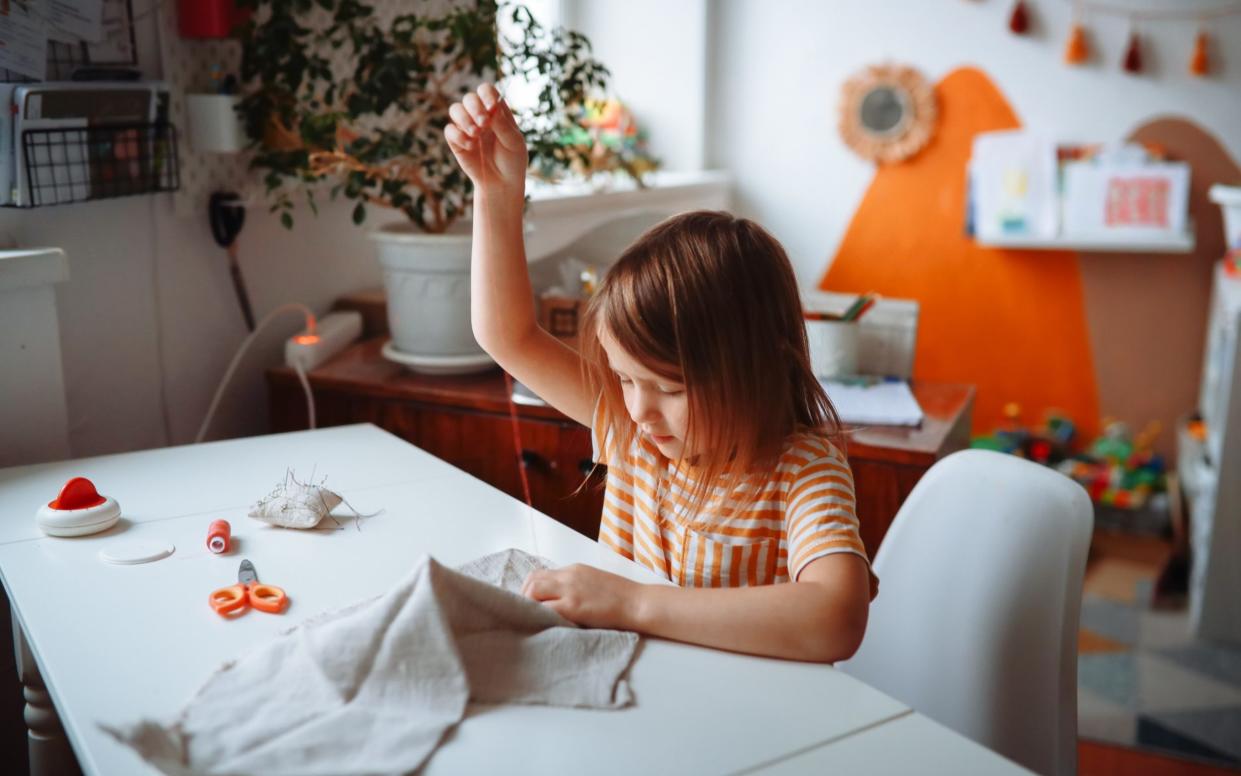 A child sewing