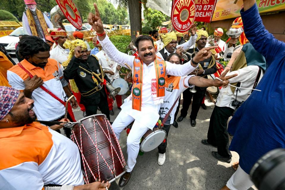 Supporters of Bharatiya Janata Party (BJP) celebrate vote counting results for India’s general election outside the BJP headquarter in New Delhi (AFP via Getty Images)