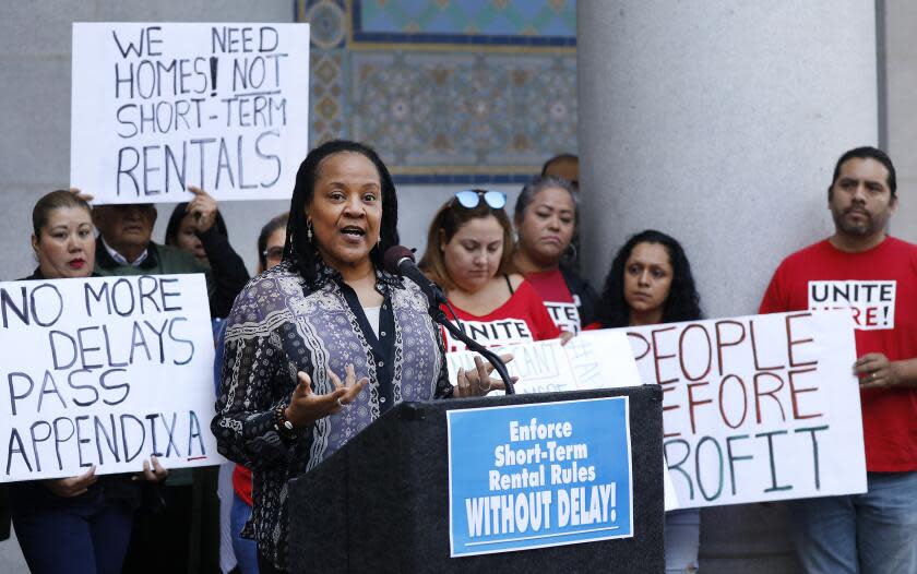 LOS ANGELES, CA - OCTOBER 15, 2019 Del Hunter-White, center, who lives in Venice joins Los Angeles City Councilman Mike Bonin and tenants and community groups critical of Airbnb-type rentals, as they urged the city to not delay the enforcement of its regulations on renting out homes for short stays at a press conference on Tuesday, Oct. 15 at Los Angeles City Hall. (Al Seib / Los Angeles Times)