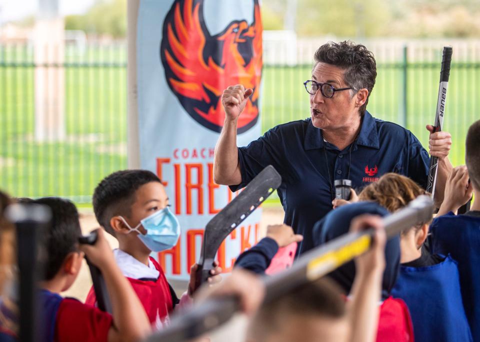 Shannon Miller, Firebirds vice president of branding and community relations, cheers kids on after finishing the Coachella Valley Firebirds’ first street hockey clinic for kids at Bagdouma Park in Coachella, Calif., Saturday, Jan. 15, 2022. 