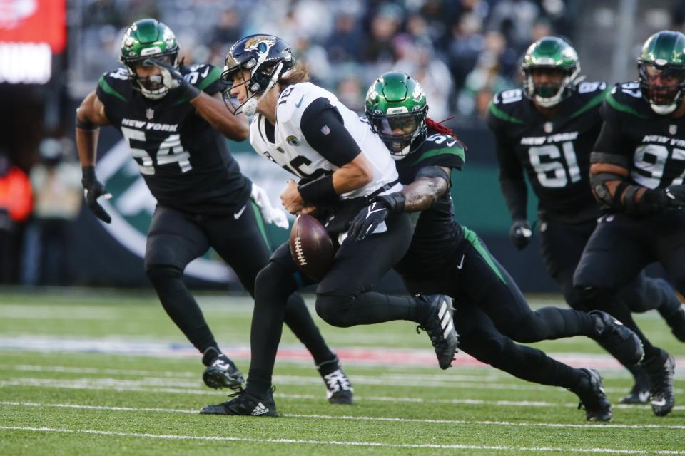 Jets linebacker C.J. Mosley (57) strips the ball from Jaguars quarterback Trevor Lawrence (16) during a second-half sack.