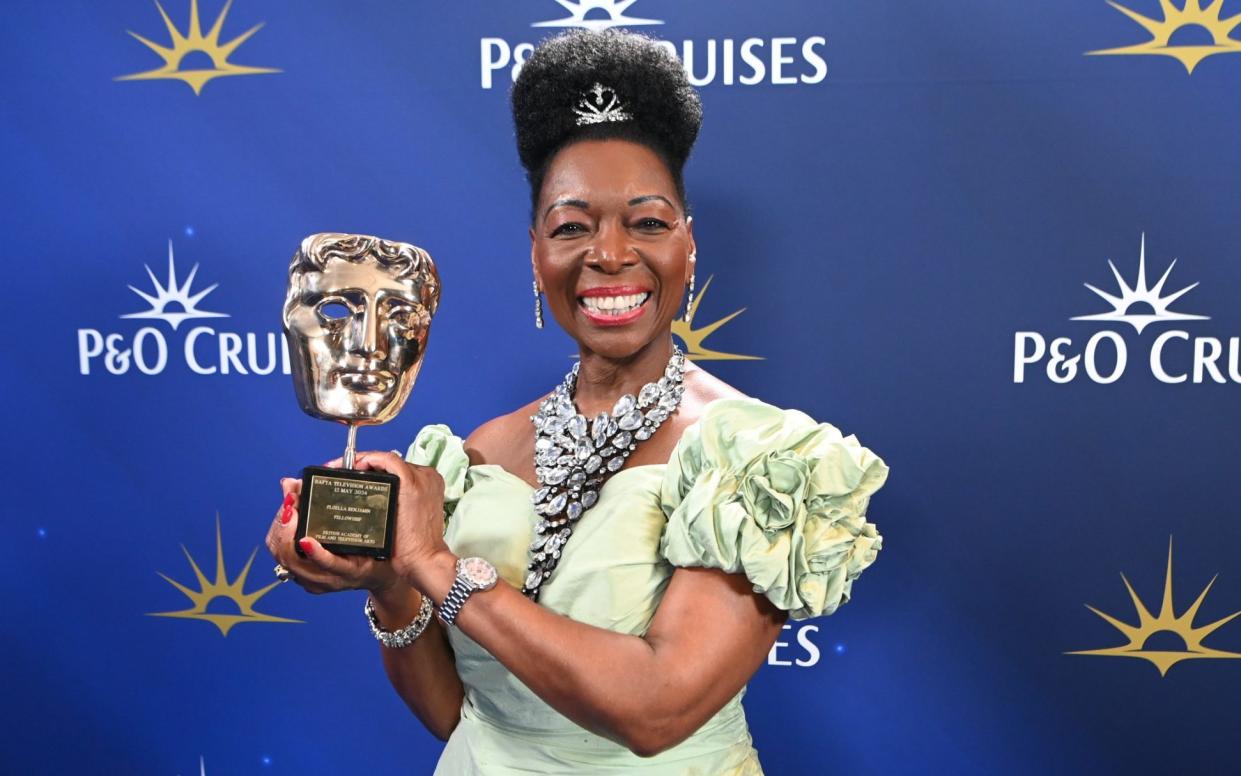 Floella Benjamin poses for a photo with her BAFTA Fellowship award