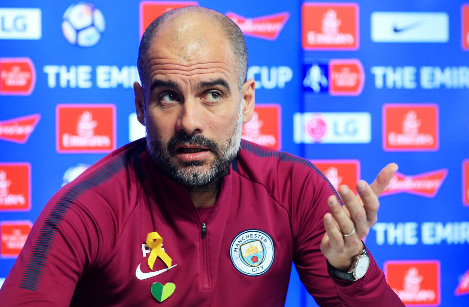 Pep Guardiola has been wearing a yellow ribbon on his shirt during press conferences and games this season. (Getty)