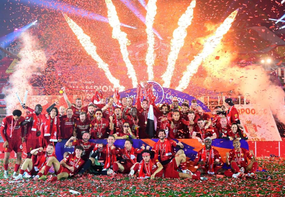 Jordan Henderson lifts the Premier League trophy at Anfield in July 2020 (Getty)