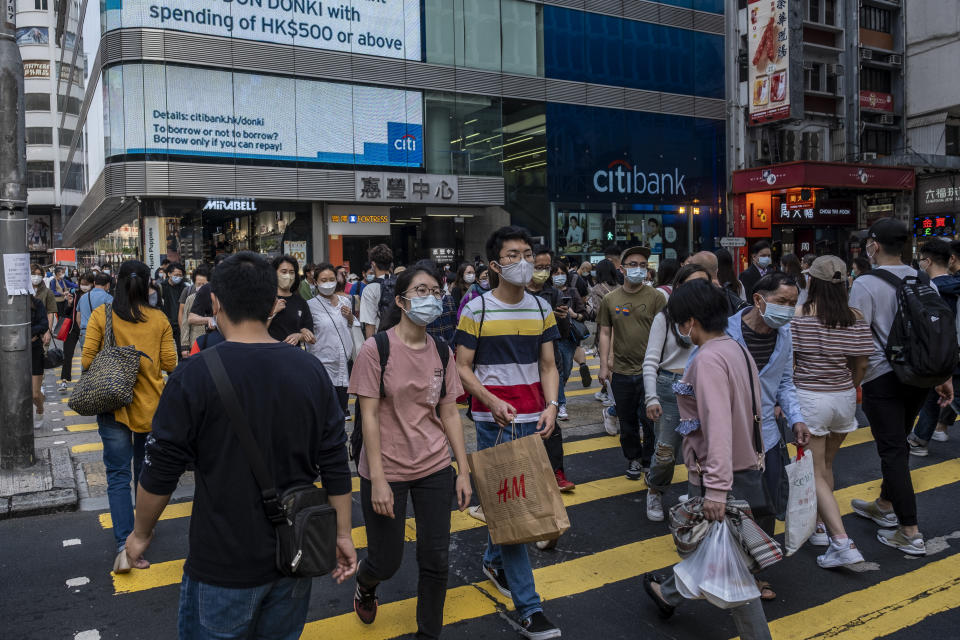 People wearing face masks walk pass a street in Hong Kong, Tuesday, March 16, 2021. Hong Kong's unemployment rate has risen to 7.2 Precent its highest level since 2004 amid the coronavirus outbreak, the labour minister warned that the job market still faces challenges with the pandemic not yet fully contained here, More than 261,000 people were left without a job in the period under review. That's 8,300 more than before, The city's jobless rate hit an all-time high of 8.5 percent during the Sars outbreak in 2003. (Photo by Vernon Yuen/NurPhoto via Getty Images)