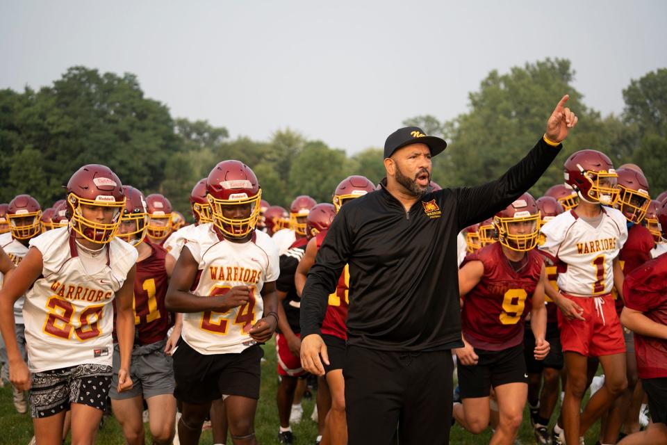 First-year Westerville North football coach Stanley Jackson Sr. leads his players during a workout Monday. Jackson played quarterback at Ohio State from 1994-97.