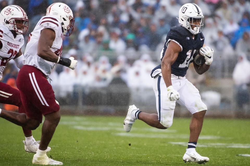 Penn State's Nick Singleton (10) breaks free on a run during the first half of a NCAA football game against Massachusetts Saturday, Oct. 14, 2023, in State College, Pa. The Nittany Lions won, 63-0.