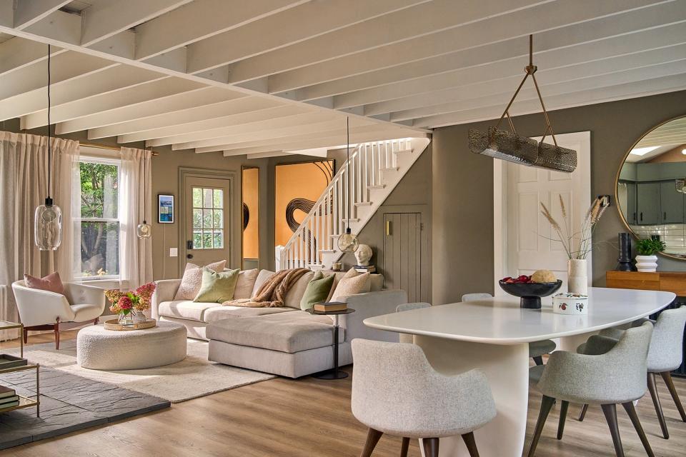 Living room and dining room with stairwell in the background