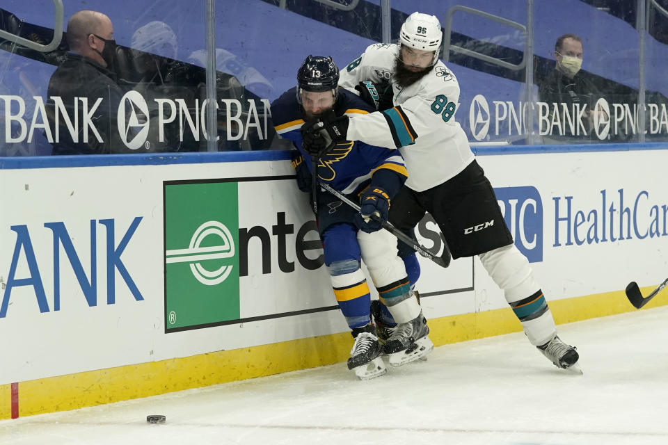 San Jose Sharks' Brent Burns (88) checks St. Louis Blues' Kyle Clifford (13) during the second period of an NHL hockey game Monday, Jan. 18, 2021, in St. Louis. (AP Photo/Jeff Roberson)