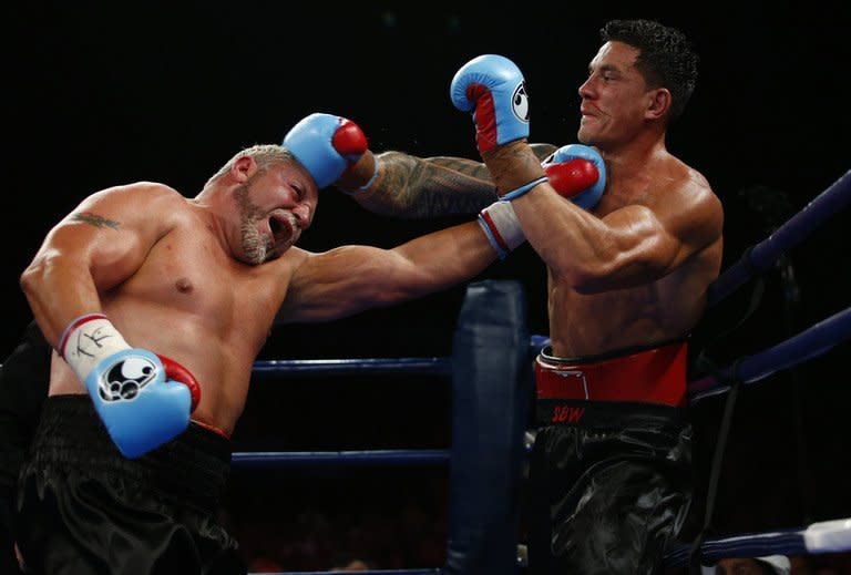 World Cup-winning ex-All Black Sonny Bill Williams (R) and Frans Botha of South Africa exchange blows during their WBA international heavyweight title fight at the Brisbane Entertainment Centre in Australia, on February 8, 2013. Williams added another crown to his career after beating veteran boxer Botha