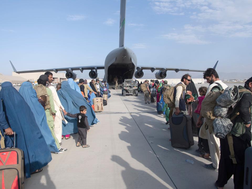 In this image provided by the U.S. Air Force, U.S. Air Force loadmasters and pilots assigned to the 816th Expeditionary Airlift Squadron, load people being evacuated from Afghanistan onto a U.S. Air Force C-17 Globemaster III at Hamid Karzai International Airport in Kabul, Afghanistan, Tuesday, Aug. 24, 2021.