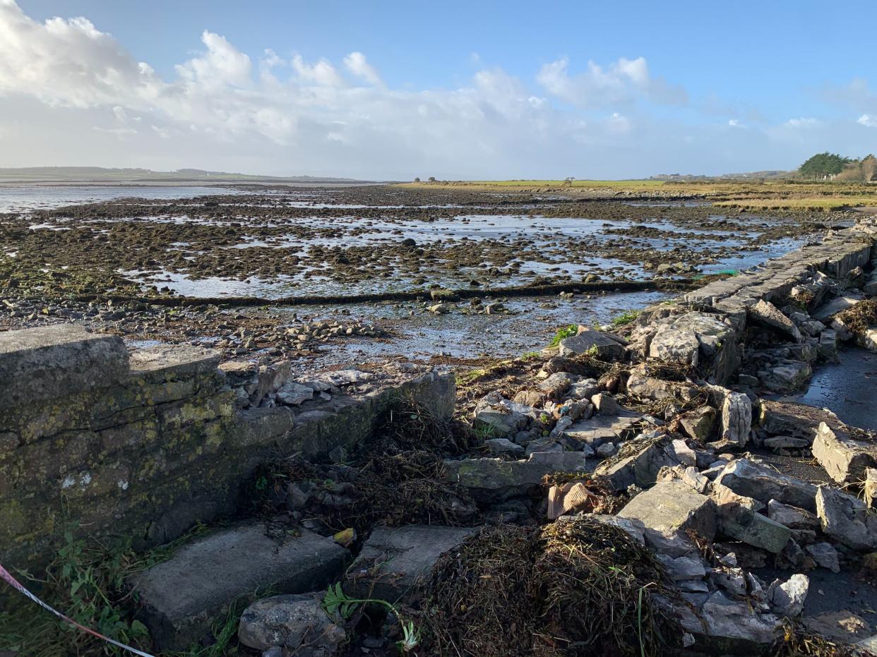 The debris left behind after Storm Debi wiped out the sea wall on the Coast Road beside Oranmore Train Station, Co Galway (PA)