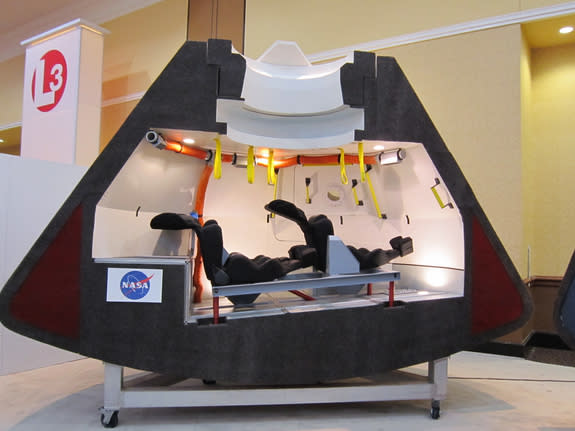 A model of Boeing's CST-100 space capsule shows the crew-carrying craft's interior design. The CST-100, which can carry up to seven astronauts, could fly its first manned mission by 2015 or 2016, Boeing officials have said.