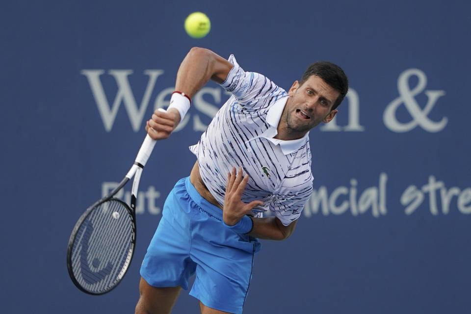 Novak Djokovic, of Serbia, serves to Daniil Medvedev, of Russia, during the Western & Southern Open tennis tournament Saturday, Aug. 17, 2019, in Mason, Ohio. (AP Photo/John Minchillo)