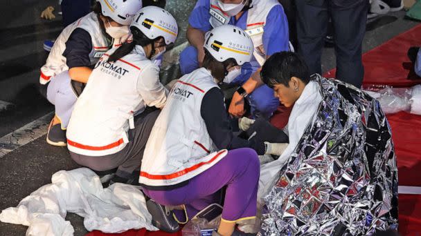 PHOTO: A man receives medical help from rescue team members at the scene where dozens of people were injured in a stampede during a Halloween festival in Seoul,  South Korea, Oct. 30, 2022.  (Kim Hong-ji/Reuters)