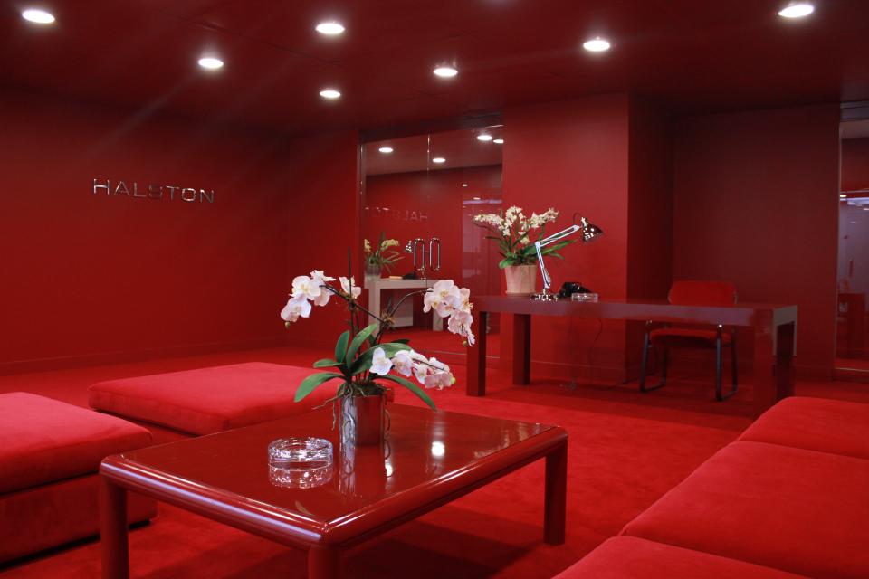 For the contemporary red sofas in Halston’s office, set decorator Cherish M. Hale sourced modular armless pieces from the home furnishings site Article. They also make an appearance in Halston’s other interiors in the series.