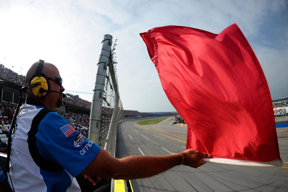 TALLADEGA, AL - MAY 05: An official in the flagstand waves the red flag during the NASCAR Nationwide Series Aaron's 312 at Talladega Superspeedway on May 5, 2012 in Talladega, Alabama. (Photo by Jared C. Tilton/Getty Images)