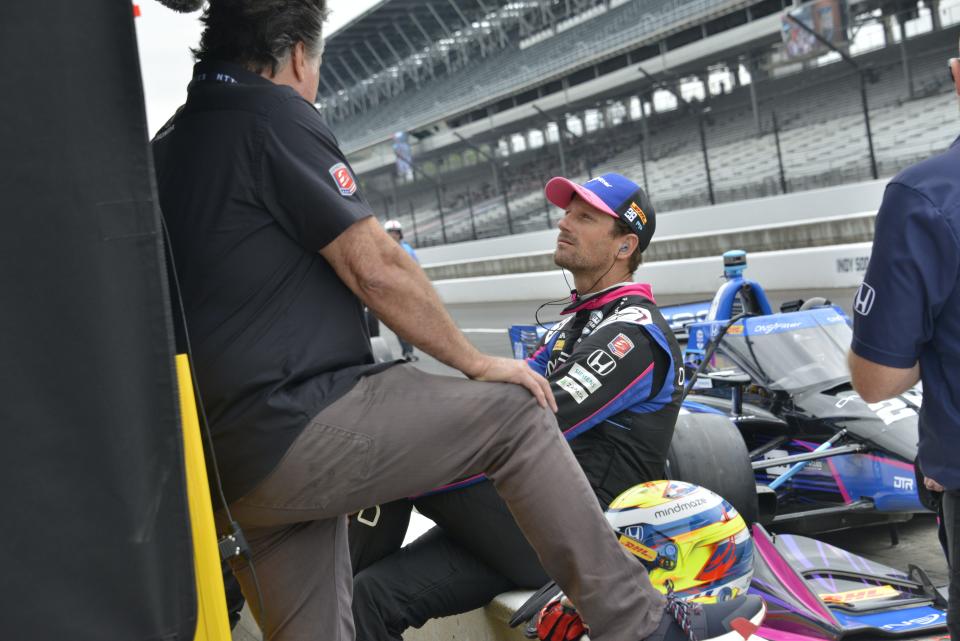 On Friday, May 12, 2023, Andretti Autosport driver Romain Grosjean (28), right, talks to team owner Michael Andretti, left, in the pit area during qualifications for the GMR Grand Prix at Indianapolis Motor Speedway. 