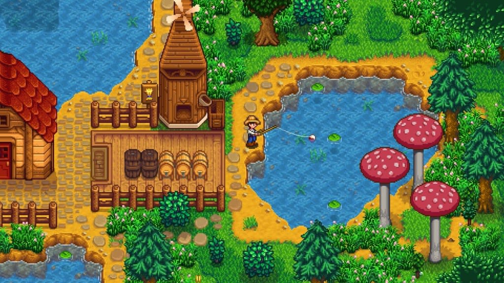 Stardew Valley: a character is fishing in a small lake behind a mill.