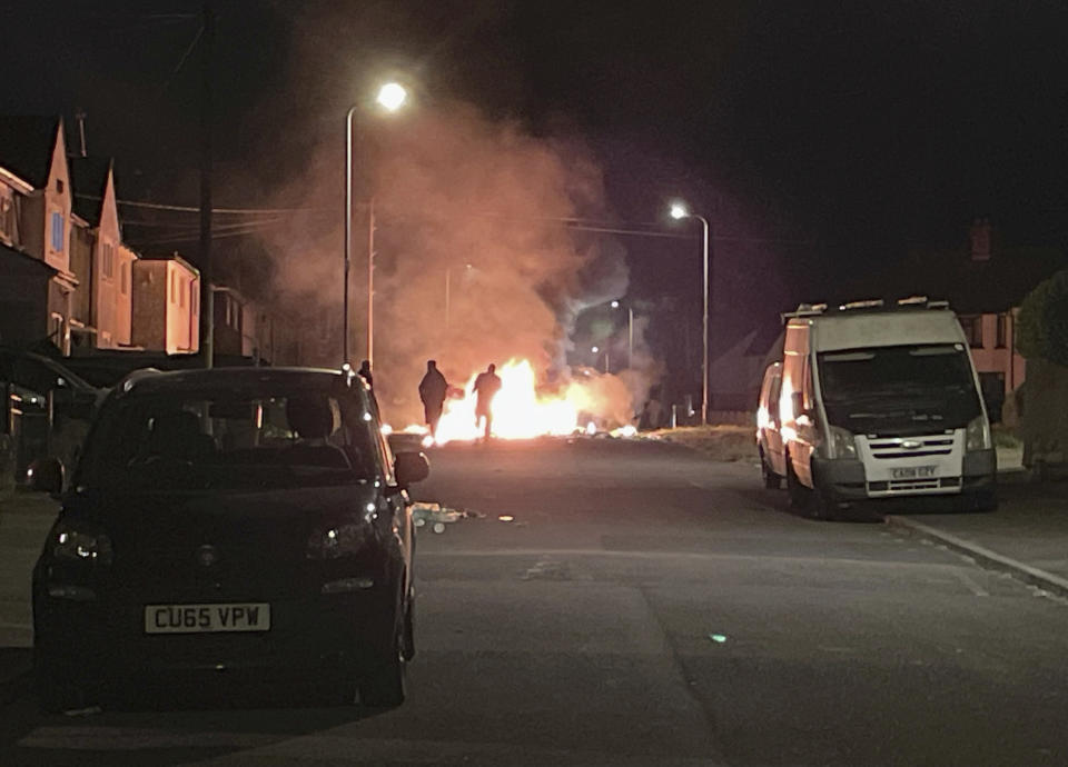 A car burns after being set on fire, on Highmead Road, Ely, in Cardiff, after a crash following a serious road traffic collision on Snowden Road in Ely in Cardiff, Tuesday, May 23, 2023. A few cars were set ablaze and objects were hurled at police after a traffic accident Monday night in the Welsh capital Cardiff grew into what officials described as “large scale disorder.” (Bronwen Weatherby/PA via AP)