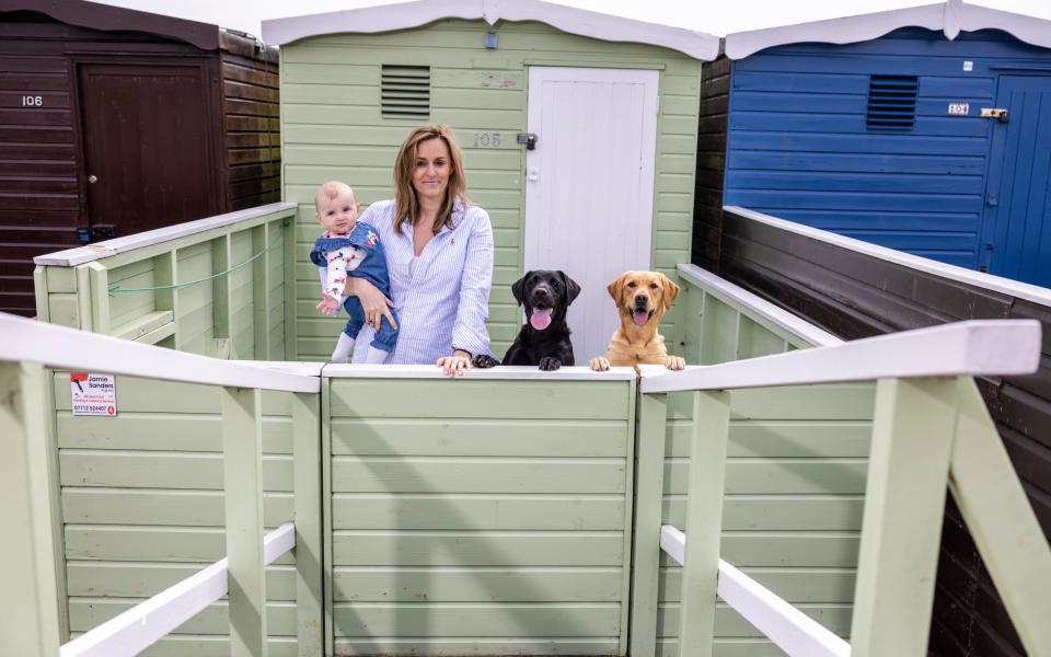 Natasha garton with baby Elise and dogs Frankie and Tally in their beach hut Frinton On Sea - Heathcliff O'Malley 