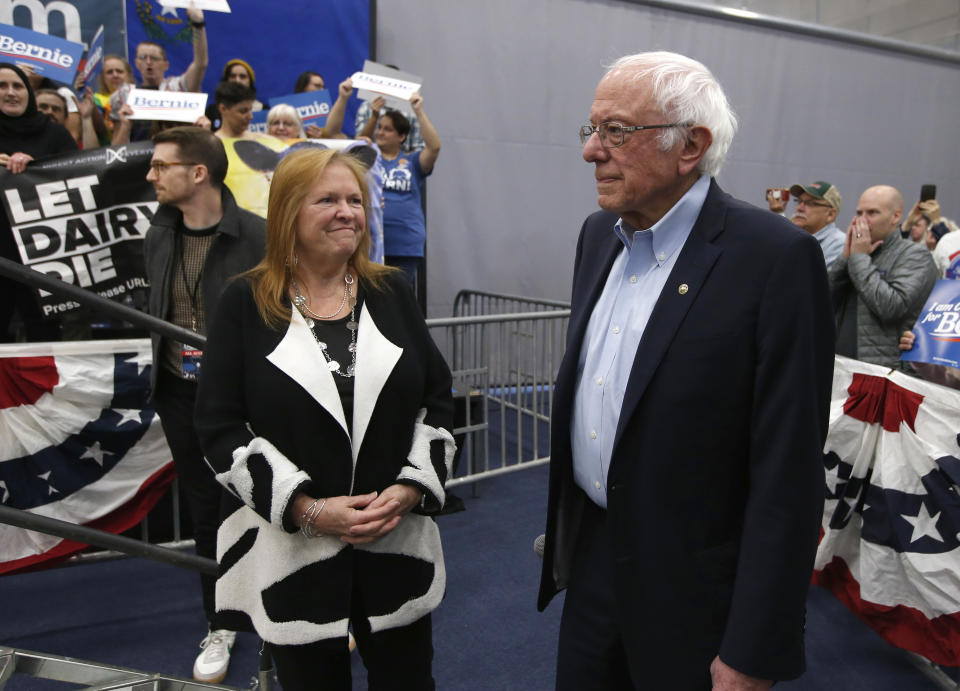 Democratic presidential candidate Sen. Bernie Sanders I-Vt., waits, with his wife Jane, left, as protestors who interrupted his campaign event were removed from the stage, in Carson City, Nev., Sunday, Feb. 16, 2020. Sanders returned after the demonstrator's were removed. (AP Photo/Rich Pedroncelli)