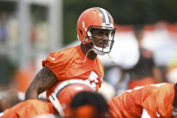 Cleveland Browns quarterback Deshaun Watson stretches during the NFL football team's training camp, Monday, Aug. 1, 2022, in Berea, Ohio. Watson was suspended for six games on Monday after being accused by two dozen women in Texas of sexual misconduct during massage treatments, in what a disciplinary officer said was behavior “more egregious than any before reviewed by the NFL.” (AP Photo/Nick Cammett)