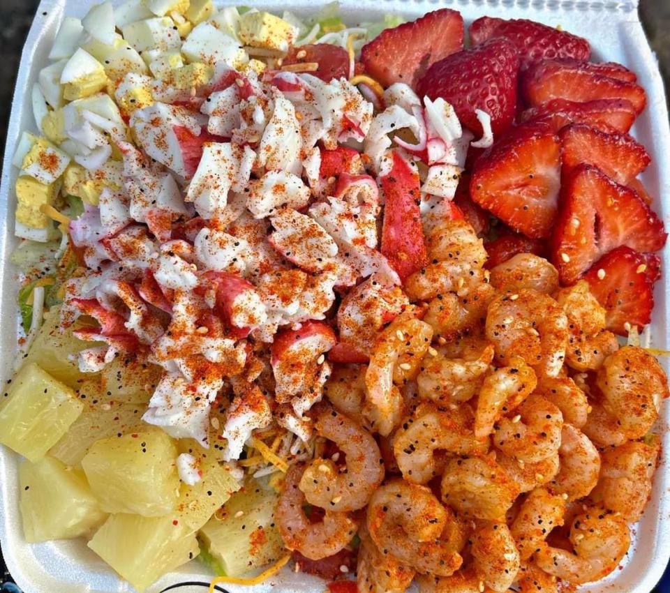 The Seaside from The Salad Spot 2. This salad includes cheddar cheese, cucumbers, tomatoes, red onions, carrots, yellow peppers, shrimp and crab on a bed on a bed of iceberg lettuce for $13.99 regular or $15.99 large. The Seaside salad pictured above includes add-ons of strawberries and pineapple for an extra charge.