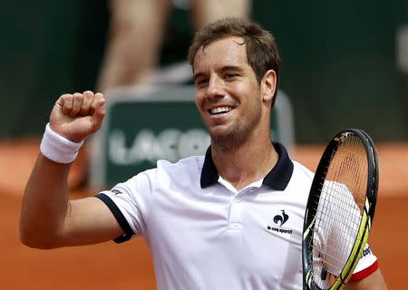 Richard Gasquet of France celebrates after beating Carlos Berlocq of Argentina during their men's singles match at the French Open tennis tournament at the Roland Garros stadium in Paris, France, May 29, 2015. REUTERS/Pascal Rossignol