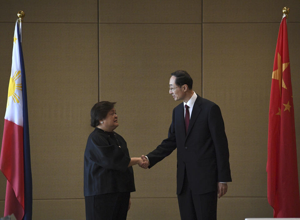 Theresa Lazaro, left, Philippines' Undersecretary for Bilateral Relations and Asian Affairs of the Department of Foreign Affairs, shake hands with Sun Weidong, China's Vice Foreign Minister, prior to the start of the Philippines-China Foreign Ministry consultation meeting at a hotel in Manila on Thursday, March 23, 2023.(Ted Aljibe/Pool via AP)