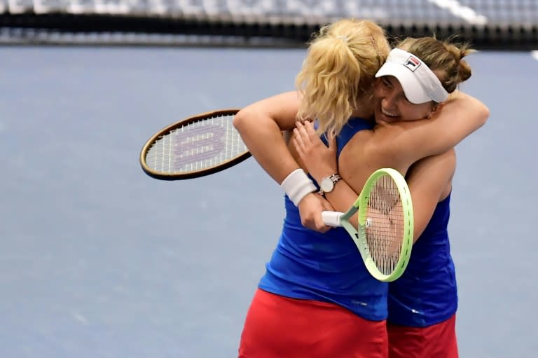 Czech Republic's Barbora Krejcikova (R) and Katerina Siniakova celebrate their doubles win (CRISTINA QUICLER)