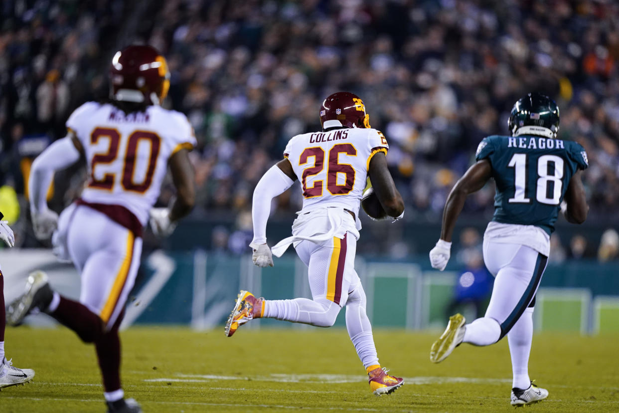 Washington Football Team's Landon Collins (26) runs after recovering a fumble during the first half of an NFL football game against the Philadelphia Eagles, Tuesday, Dec. 21, 2021, in Philadelphia. (AP Photo/Matt Slocum)