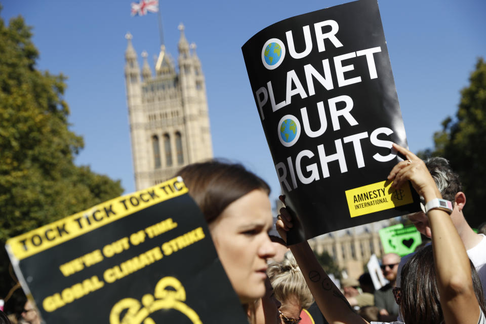 A climate protester holds up her placard as she takes part in a demonstration near Parliament square in London, Friday, Sept. 20, 2019. (Photo: Alastair Grant/AP)