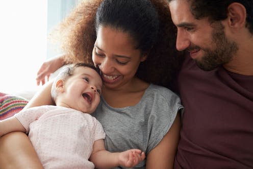 <span class="caption">By six months, the vast majority of parents have bonded with their baby.</span> <span class="attribution"><a class="link " href="https://www.shutterstock.com/image-photo/parents-sitting-on-sofa-cuddling-baby-562380934" rel="nofollow noopener" target="_blank" data-ylk="slk:Monkey Business Images;elm:context_link;itc:0;sec:content-canvas">Monkey Business Images</a></span>