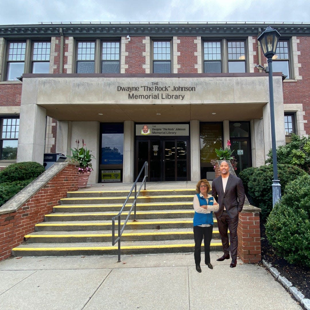 Barrington Public Library director Kris Chin poses in front of the newly rebranded library Saturday morning with a cardboard cutout of Dwayne "The Rock" Johnson.