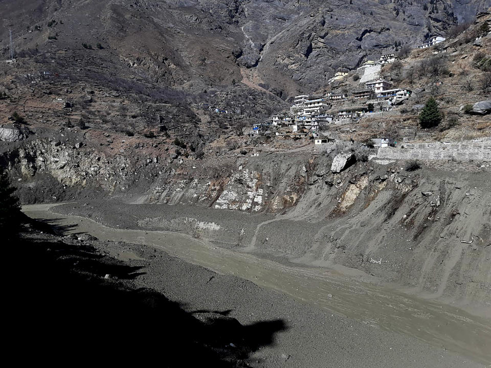 Mud and slash are seen in the Dhauliganga River after a portion of Nanda Devi glacier broke off in Tapovan area of the northern state of Uttarakhand, Sunday, Feb.7, 2021. (AP Photo)