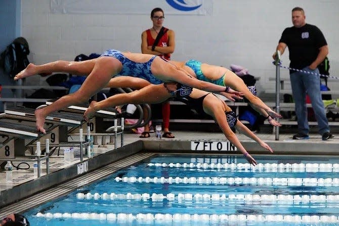 Old Bridge swimmers participate in a prevous practice for a purpose event