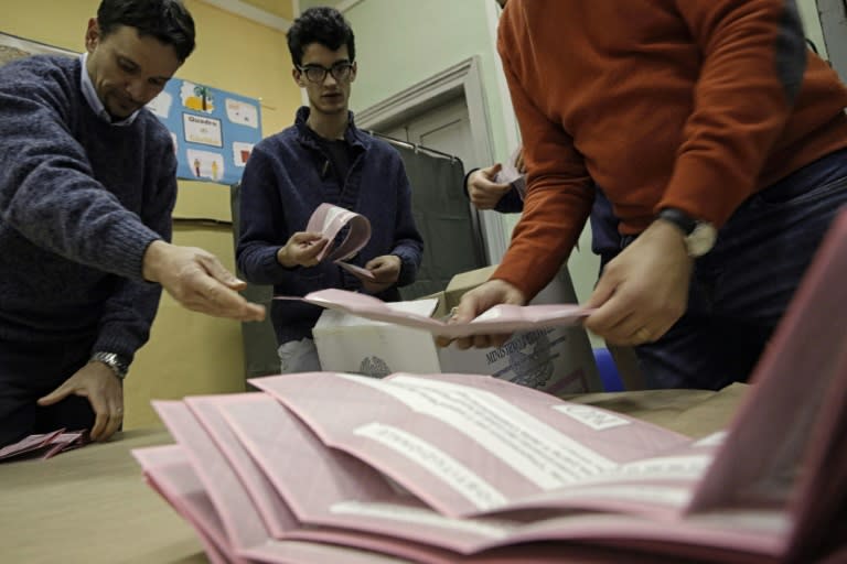 Scrutineers count the referendum ballots on December 4, 2016 in a polling station in Saluzzo near Turin