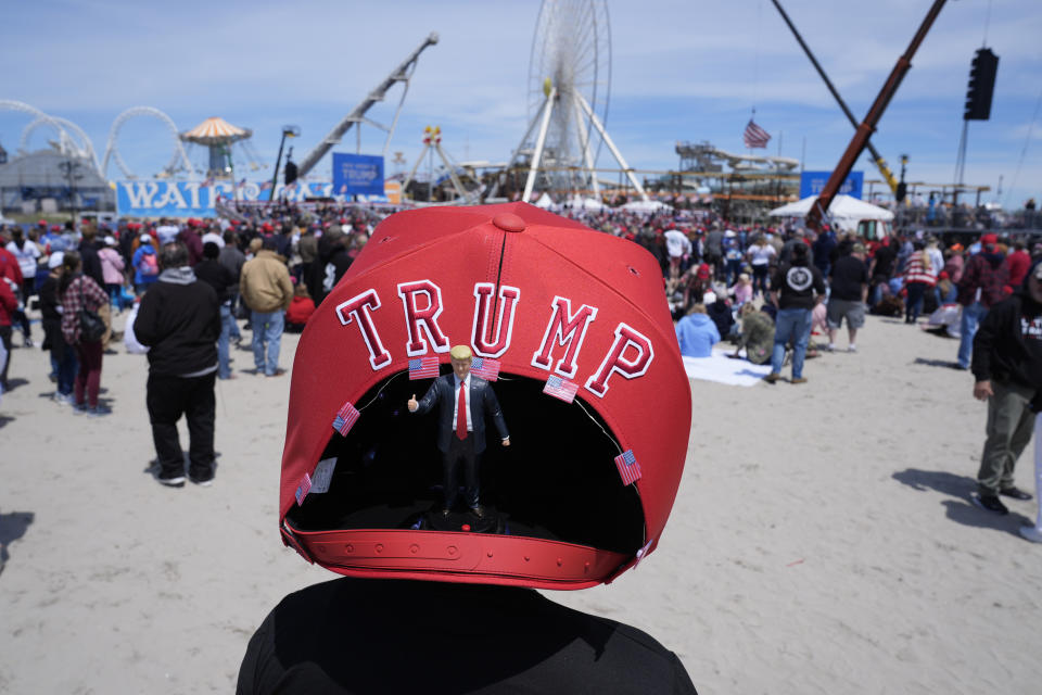 Anthony Pahopin wears an over-sized Donald Trump cap before a campaign rally for Republican presidential candidate former President Trump in Wildwood, N.J., Saturday, May 11, 2024. (AP Photo/Matt Rourke)