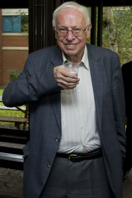 Sweden's Tomas Lindahl, emeritus director of Cancer Research UK, poses with a cup of champagne at Clare Hall Laboratory in Potters Bar after he was jointly awarded the Nobel Chemistry prize on October 7, 2016