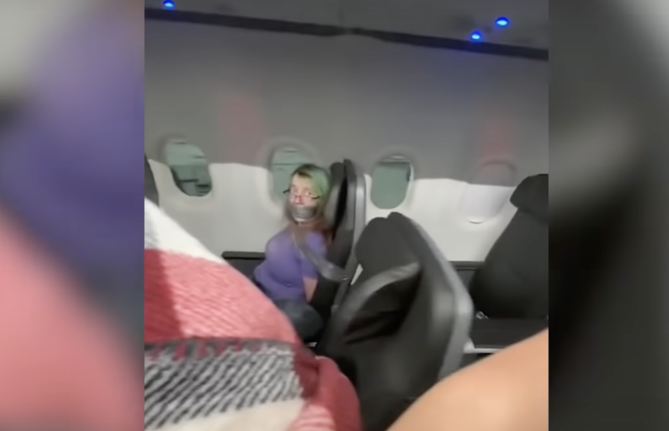 A woman is duct taped to a chair on an American Airlines flight. 