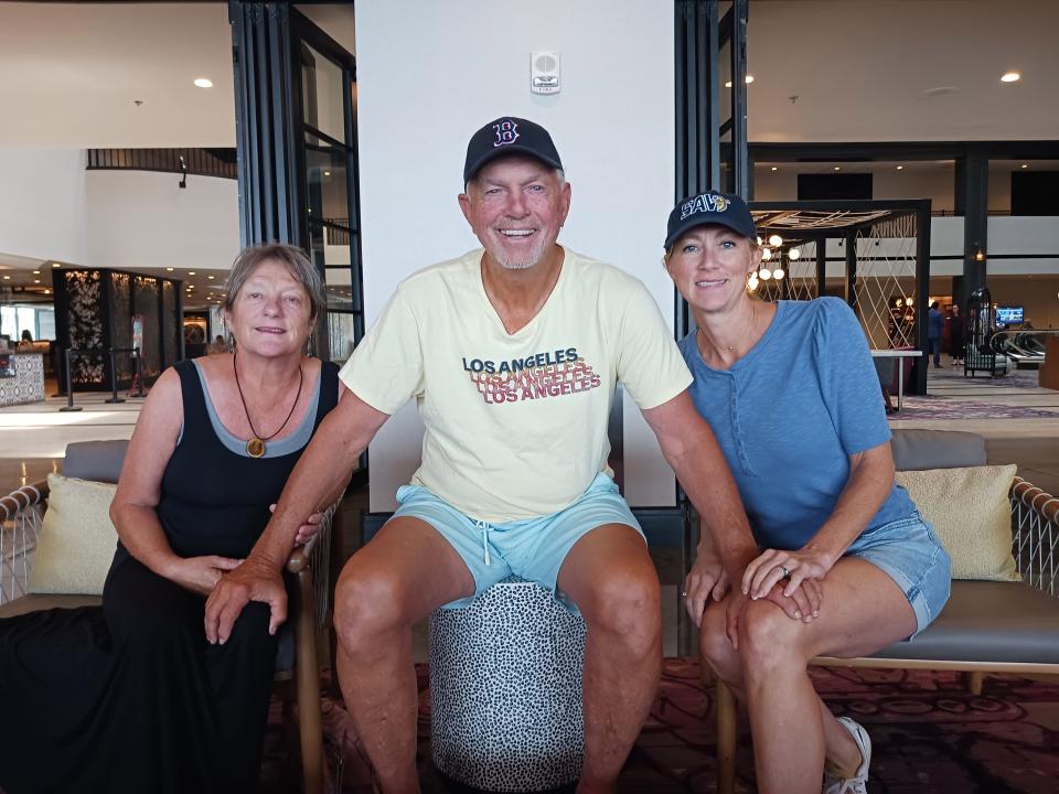 Former major league pitcher Bill Lee, 75, sits with his wife Diana, left, and his daughter Caitlin Burkes, for an interview at a Savannah hotel on Tuesday, Aug. 23, 2022. Lee pledges to continue to pitch after a doctor-ordered six-week break following a medical procedure. The Savannah Bananas Premier Team pitcher had collapsed Friday night while warming up at an exhibition game at Grayson Stadium.