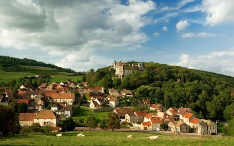 The Chateau de la Rochepot is seen above La Rochepot, a winemaking village near Beaune - Credit:  Ian Shaw /Alamy