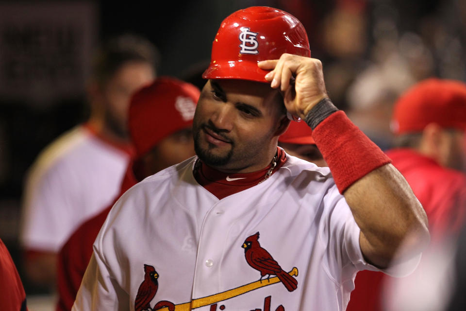 ST LOUIS, MO - OCTOBER 28: Albert Pujols #5 of the St. Louis Cardinals celebrates in the dugout after scoring on a Rafael Furcal #15 hit by pitch with the bases loaded in the fifth inning during Game Seven of the MLB World Series at Busch Stadium on October 28, 2011 in St Louis, Missouri. (Photo by Jamie Squire/Getty Images)