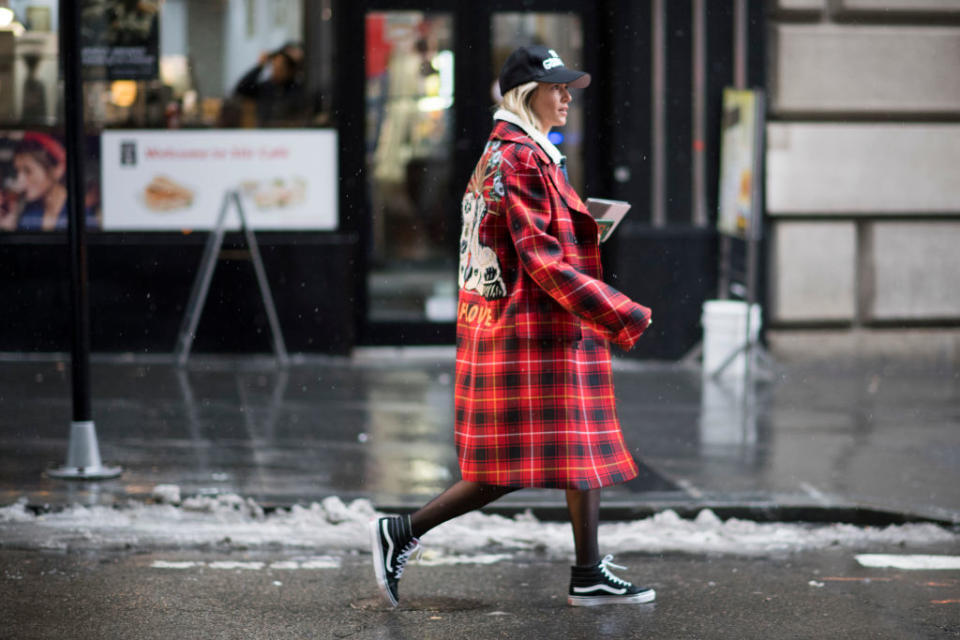 <p>This street style star embodies a skater-girl style that you can easily replicate. A plaid coat is a great option for those looking to opt out of another neutral look. Pair it with a baseball cap, tights, and your favorite Vans. (Photo: Getty Images) </p>