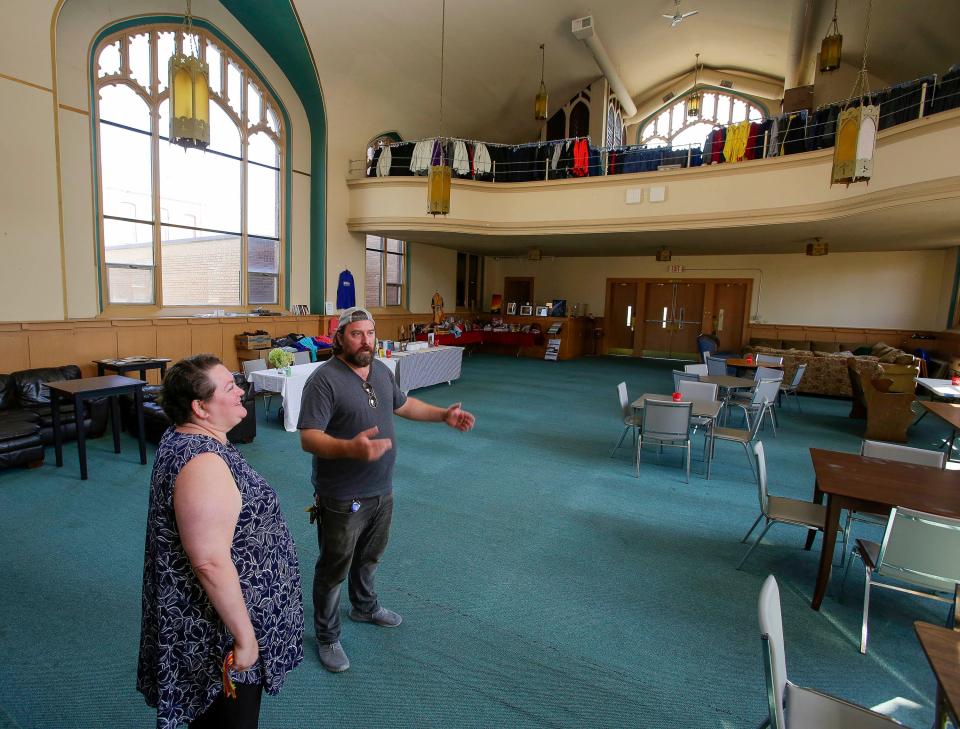 House Manager Emily Kunde, left, and The Production Farm CEO Wyatt Kuether stand in the community room which at one time was a church as seen, Wednesday, August 2, 2023, in Sheboygan Falls, Wis.
