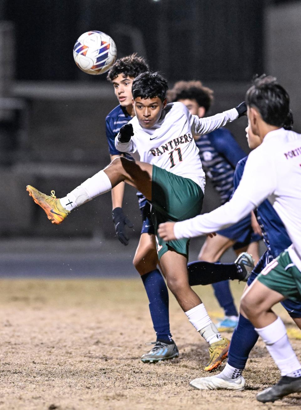 Porterville's Edwin Nava clears the ball against Redwood in an East Yosemite League high school boys soccer game Thursday, January 11, 2024.