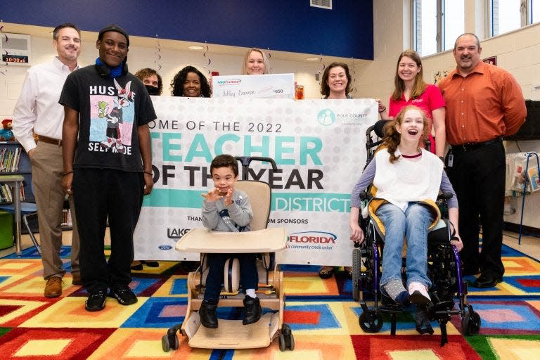 Polk County Public School district and school officials surprised Karen Siegel Academy special education curriculum coach Ashley Brannon, center, late last year when she was named a finalist for the 2022 Teacher of the Year.  She won the award Thursday night.