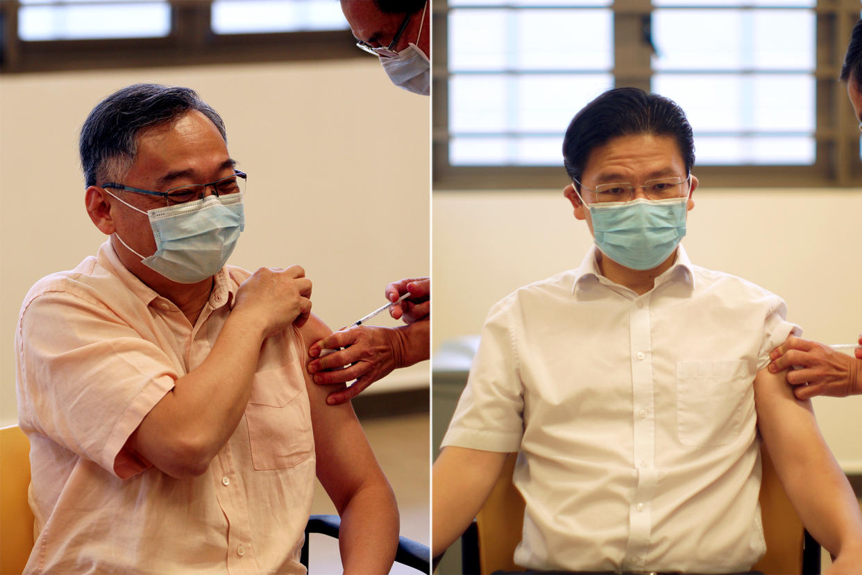 The co-chairs of the multi-ministry taskforce for COVID-19, Gan Kim Yong (left) and Lawrence Wong, receive their first doses of coronavirus vaccinations at Kwong Wai Shiu Hospital on 13 January. (PHOTOS: Ministry of Communication and Information)